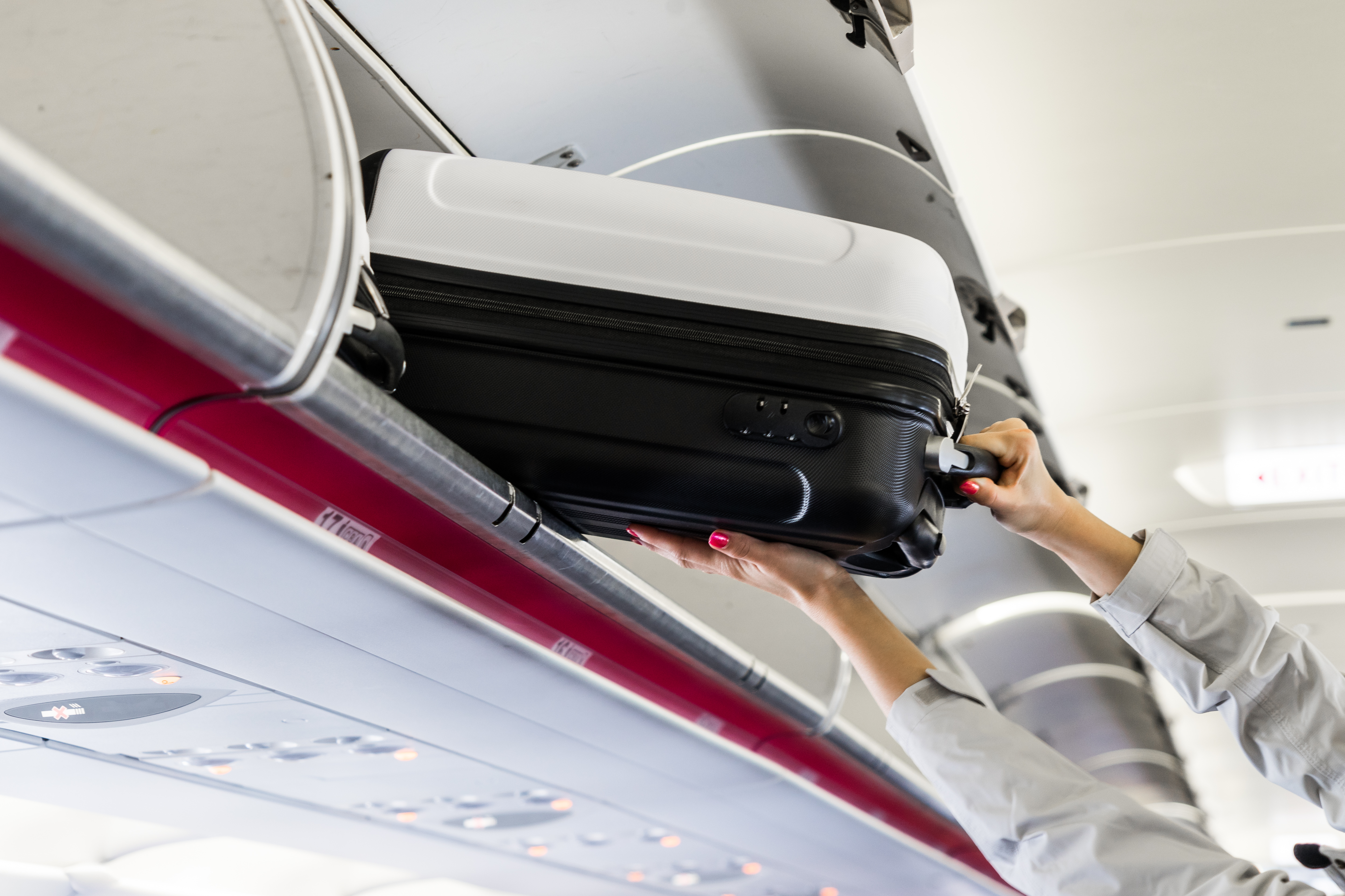 Woman carrying her luggage on a cheap flight to the Caribbean