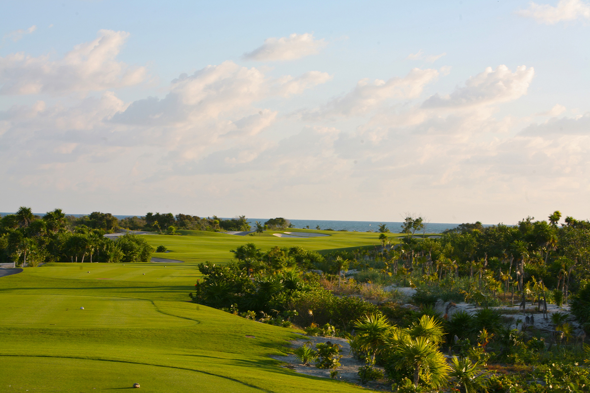 Playing golf on a Greg Norman golf course in Playa Mujeres, Cancun. 