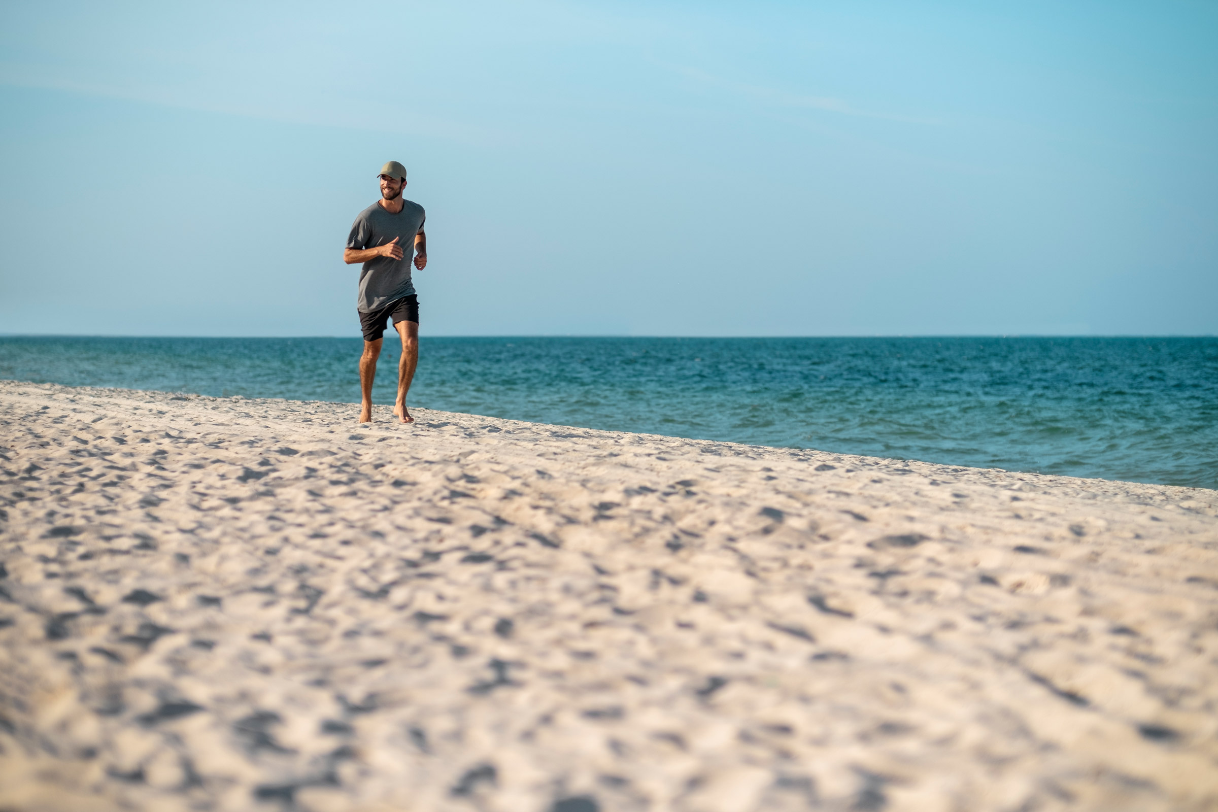 A man running along the beach in the Caribbean sun