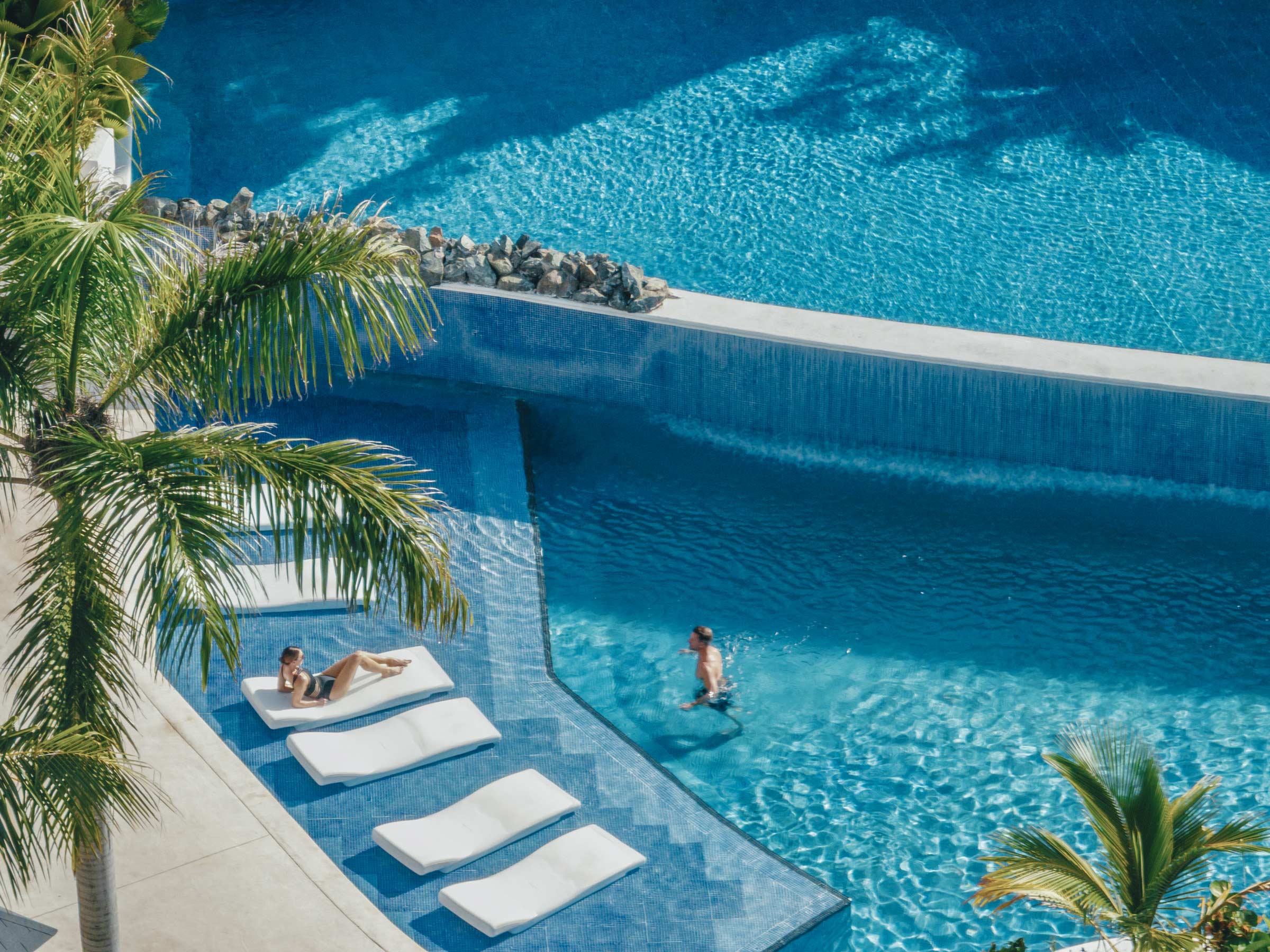 Couple relaxing in a pool in an All Inclusive resort in the Dominican Republic Couple relaxing in a pool in an All Inclusive resort in the Dominican Republic
