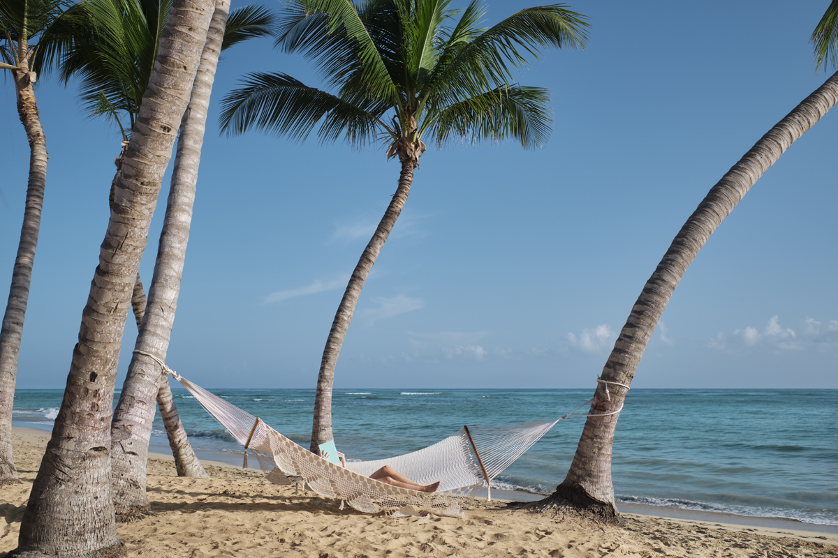 Relaxing in a hammock amidst the palm trees in a tropical paradise destination