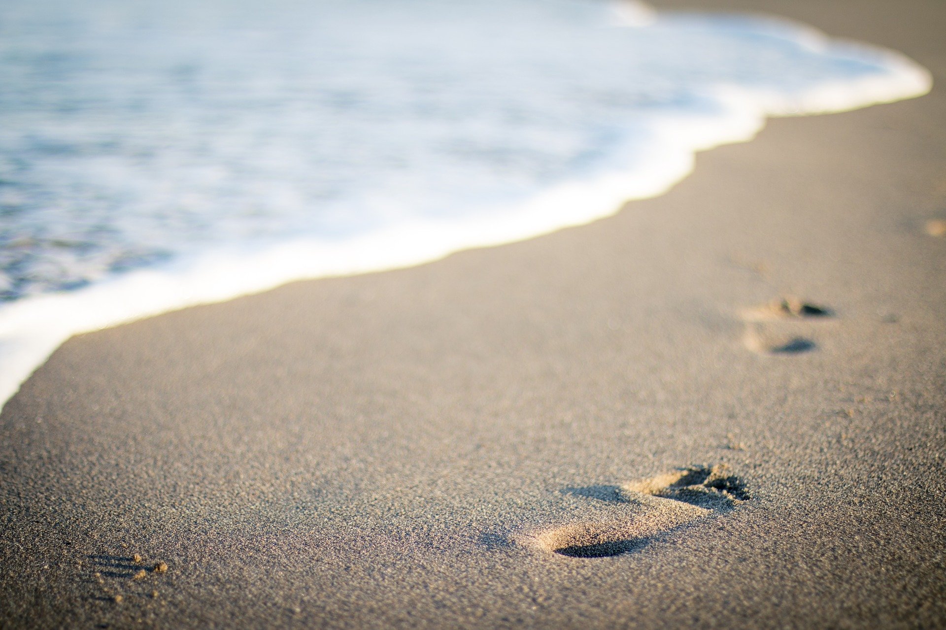 Walk barefoot along the beach when the sand is cooler