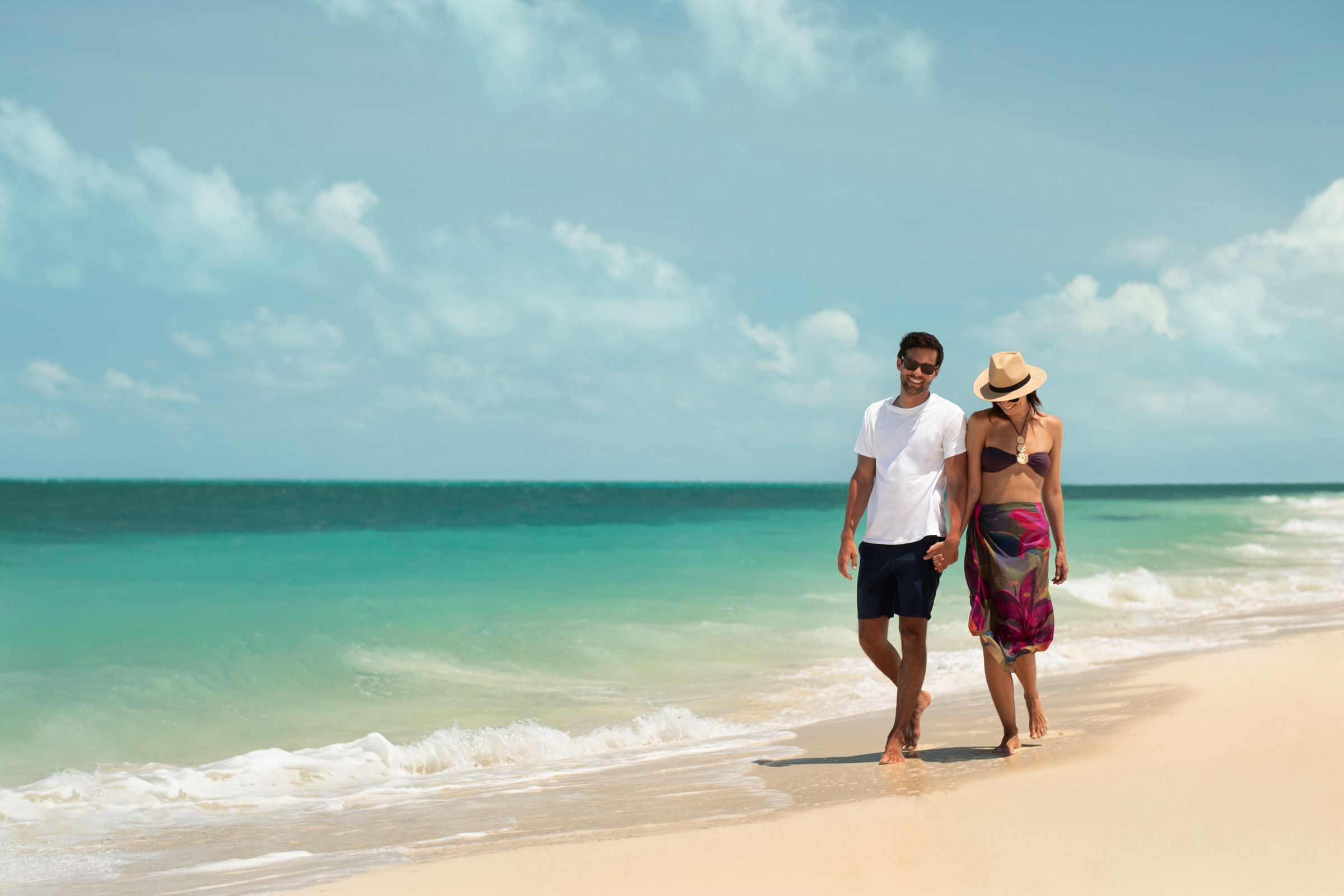 Couple walking along a Cancun Beach